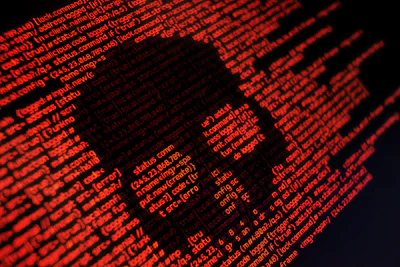 Digital red code forming skull shape, representing cybersecurity threat