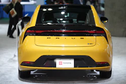Yellow Toyota Prius hybrid car displayed at automotive show
