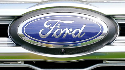 Ford automotive logo emblem on vehicle grille with blue and chrome design