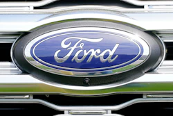 Ford automotive logo emblem on vehicle grille with blue and chrome design