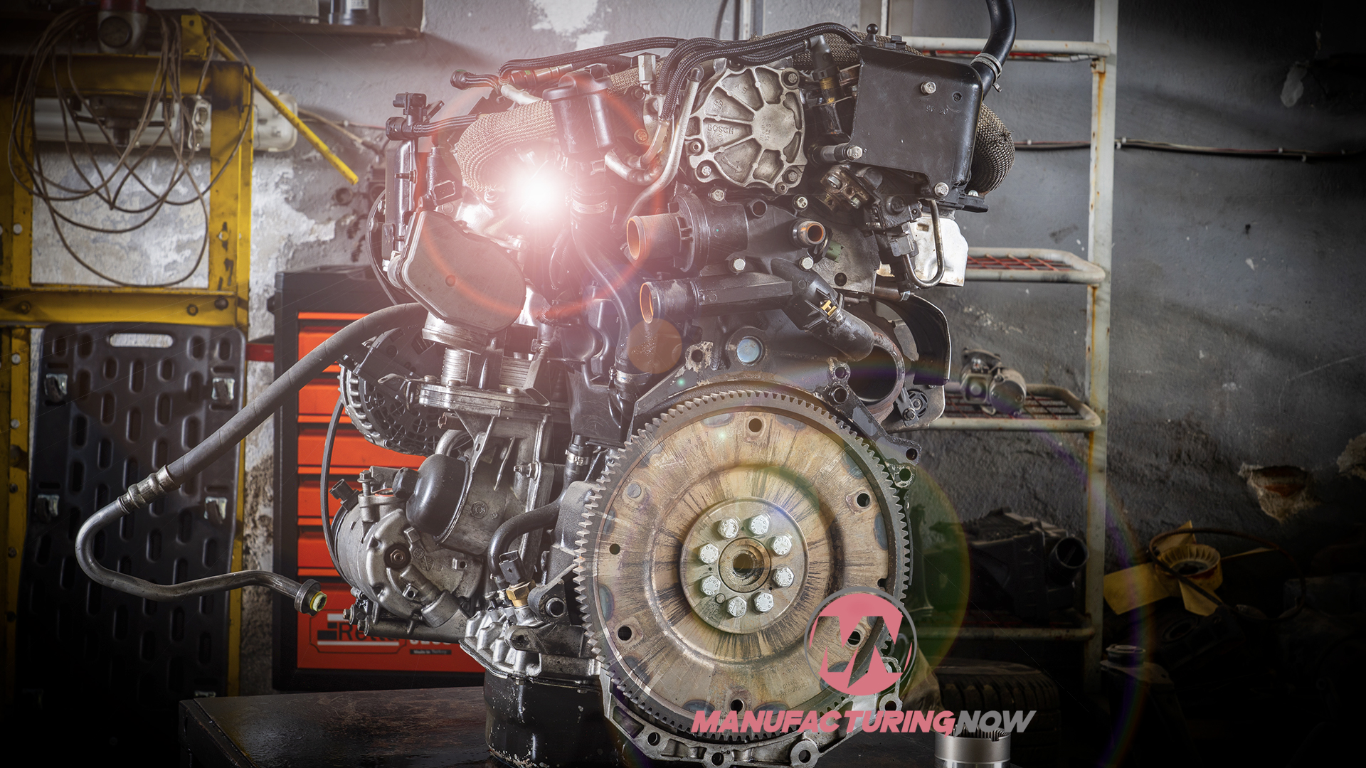 Exposed automotive engine with complex mechanical parts in industrial workshop