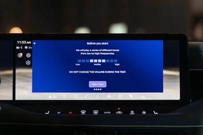 Car infotainment screen displaying audio test instructions with volume level indicators