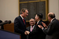 Government officials in suits shaking hands during formal meeting