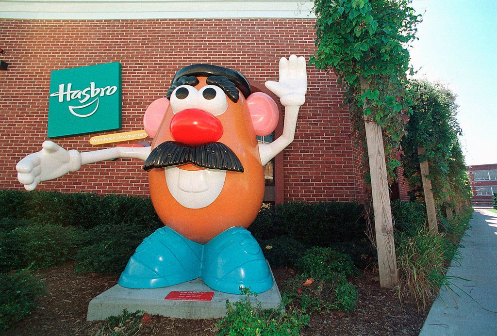 Large Mr. Potato Head statue outside Hasbro building with green logo
