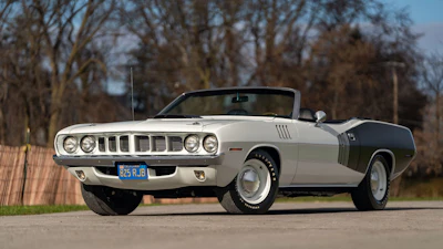 Classic white 1971 Plymouth Barracuda convertible parked outdoors