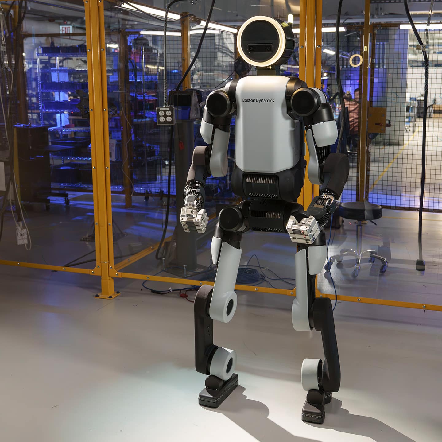 Humanoid robot with white and black body standing in industrial laboratory
