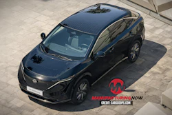 Black Nissan electric SUV parked on tiled surface with solar roof