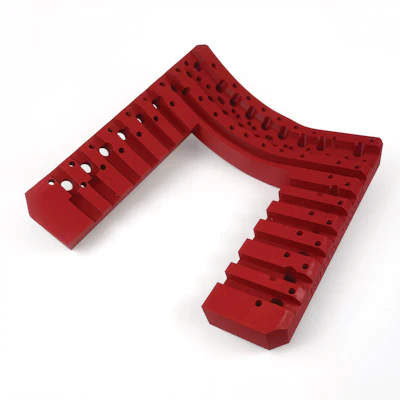 Red modular industrial component with perforated design and angular shape