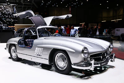 Silver Mercedes-Benz 300SL Gullwing with open doors at automotive exhibition