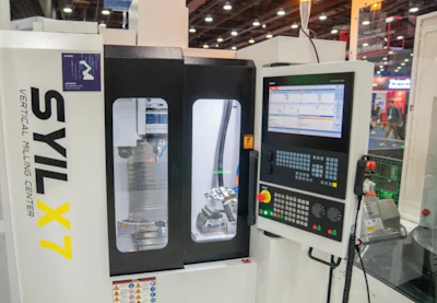 SYL X7 vertical milling machine with digital control panel at industrial exhibition