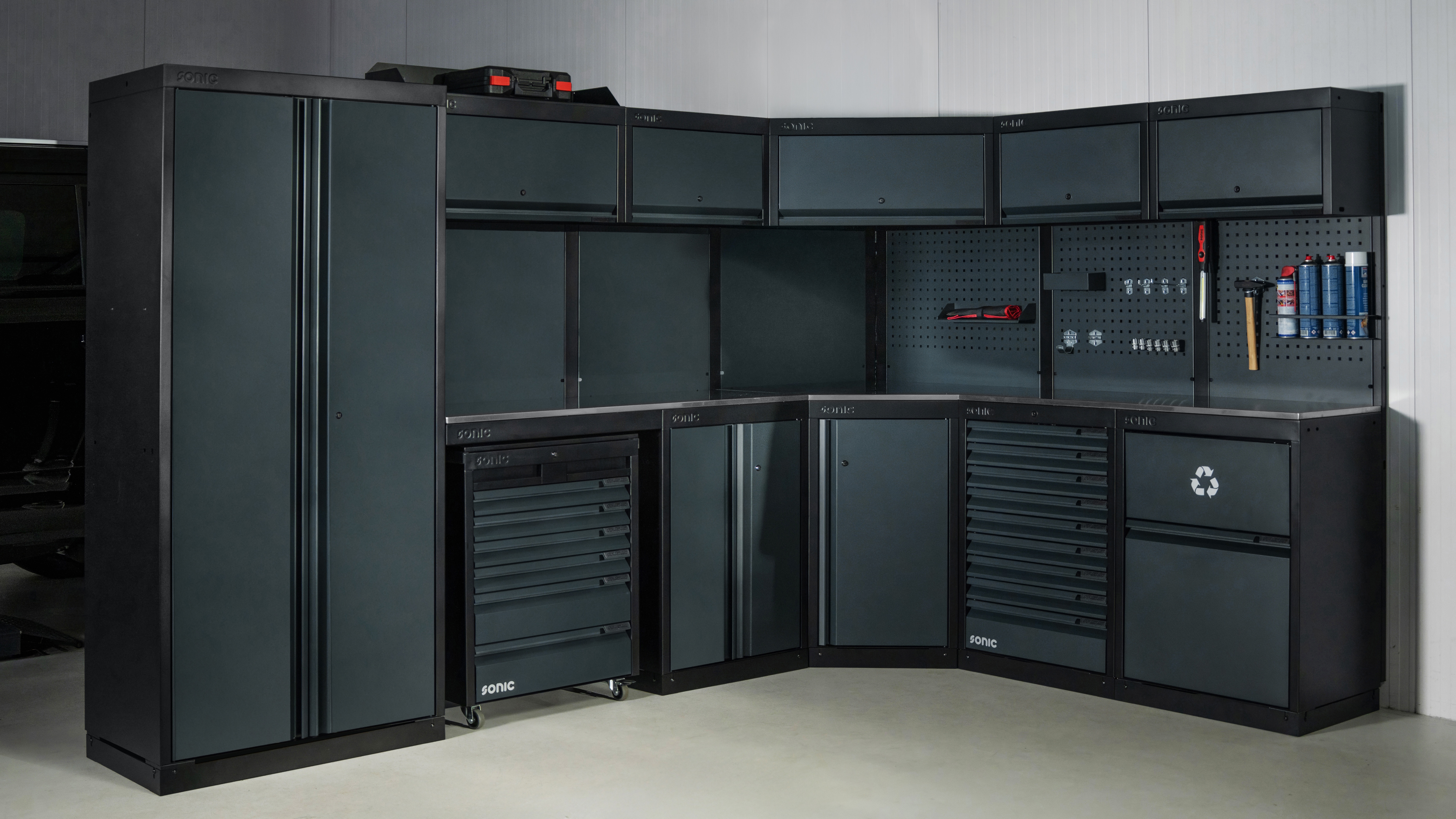 Dark gray modular garage storage system with tool drawers and wall panels