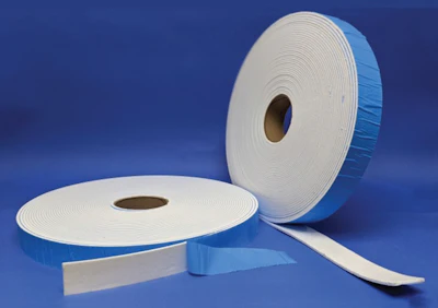 Two rolls of white foam sealing tape on blue background