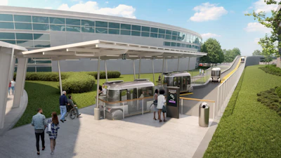 Modern transit station with buses, shelter, and accessible entrance near glass building