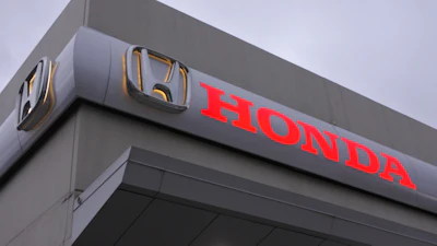 Honda corporate logo on gray building exterior with red lettering