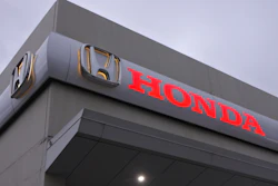 Honda corporate logo on gray building exterior with red lettering
