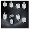 White industrial electrical components and circuit protection devices on dark background
