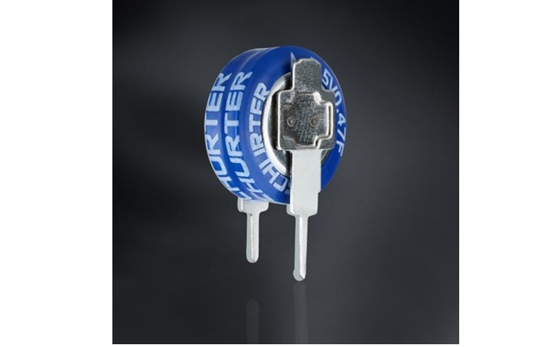 Blue circular battery or electronic component with white terminals