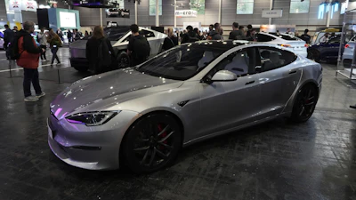 Silver Tesla Model S electric car on display at automotive conference