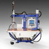 Industrial robotic welding machine with blue frame, control panel, and articulated arm for automated manufacturing