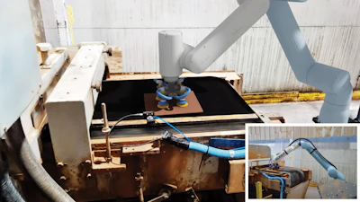 Industrial robotic arm with blue components mounted on metal platform equipment