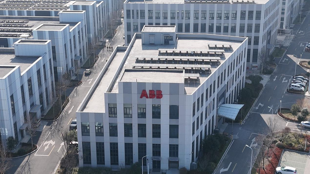 ABB corporate headquarters building with red signage in modern urban district surrounded by white office buildings