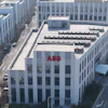 ABB corporate headquarters building with red signage in modern urban district surrounded by white office buildings