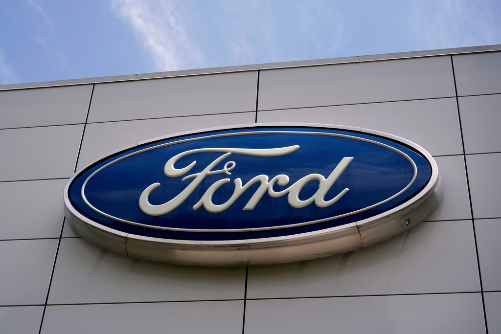 Ford logo mounted on gray building exterior signage