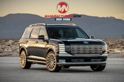 Luxury black SUV with gold wheels displayed in desert landscape at sunset