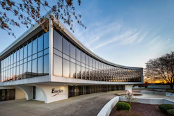 Modern EnerSys corporate headquarters building with curved glass facade and white exterior at sunset