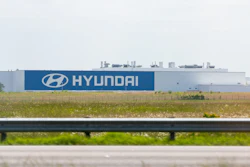 Hyundai manufacturing facility with blue branded signage along highway