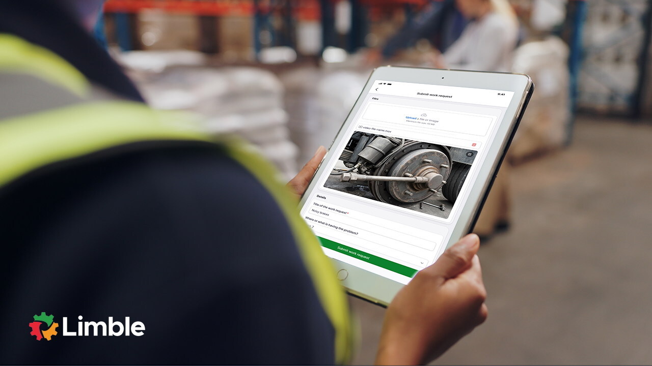 Worker in safety vest viewing maintenance documentation on tablet displaying equipment image