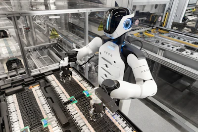 AEON humanoid robot performing assembly task on industrial manufacturing line with electronic components