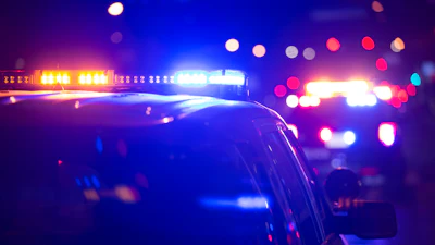 Police vehicle with flashing blue and red emergency lights at night