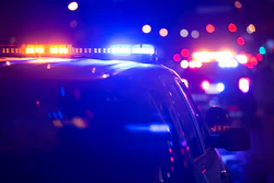 Police vehicle with flashing blue and red emergency lights at night