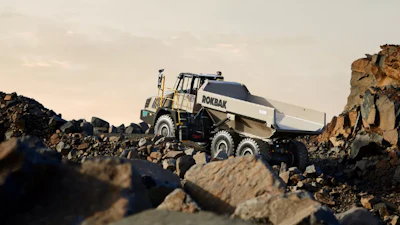 Rokbak articulated dump truck navigating rocky quarry terrain with large boulders