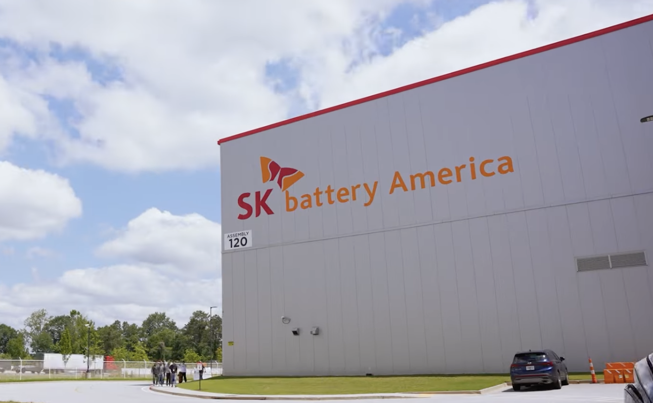 SK Battery America manufacturing facility with company logo and signage on white industrial building exterior