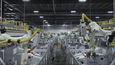 Industrial robot arms on assembly line in modern manufacturing facility with overhead lighting