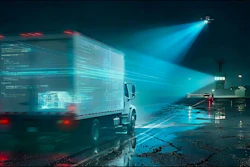 Futuristic delivery truck with holographic data overlay in nighttime industrial setting under blue spotlight