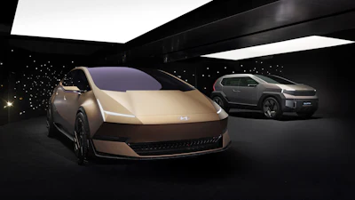 Hyundai concept electric vehicles displayed in modern showroom with ambient lighting