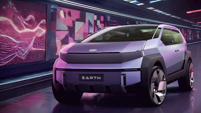 Hyundai EARTH concept electric vehicle in pink and white displayed in futuristic neon-lit showroom