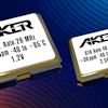 Two Aker crystal oscillators with specifications displayed on white labels against a blue gradient background