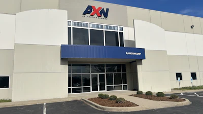 AXN Automotive Systems storefront with blue awning and glass entrance doors
