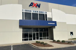 AXN Automotive Systems storefront with blue awning and glass entrance doors