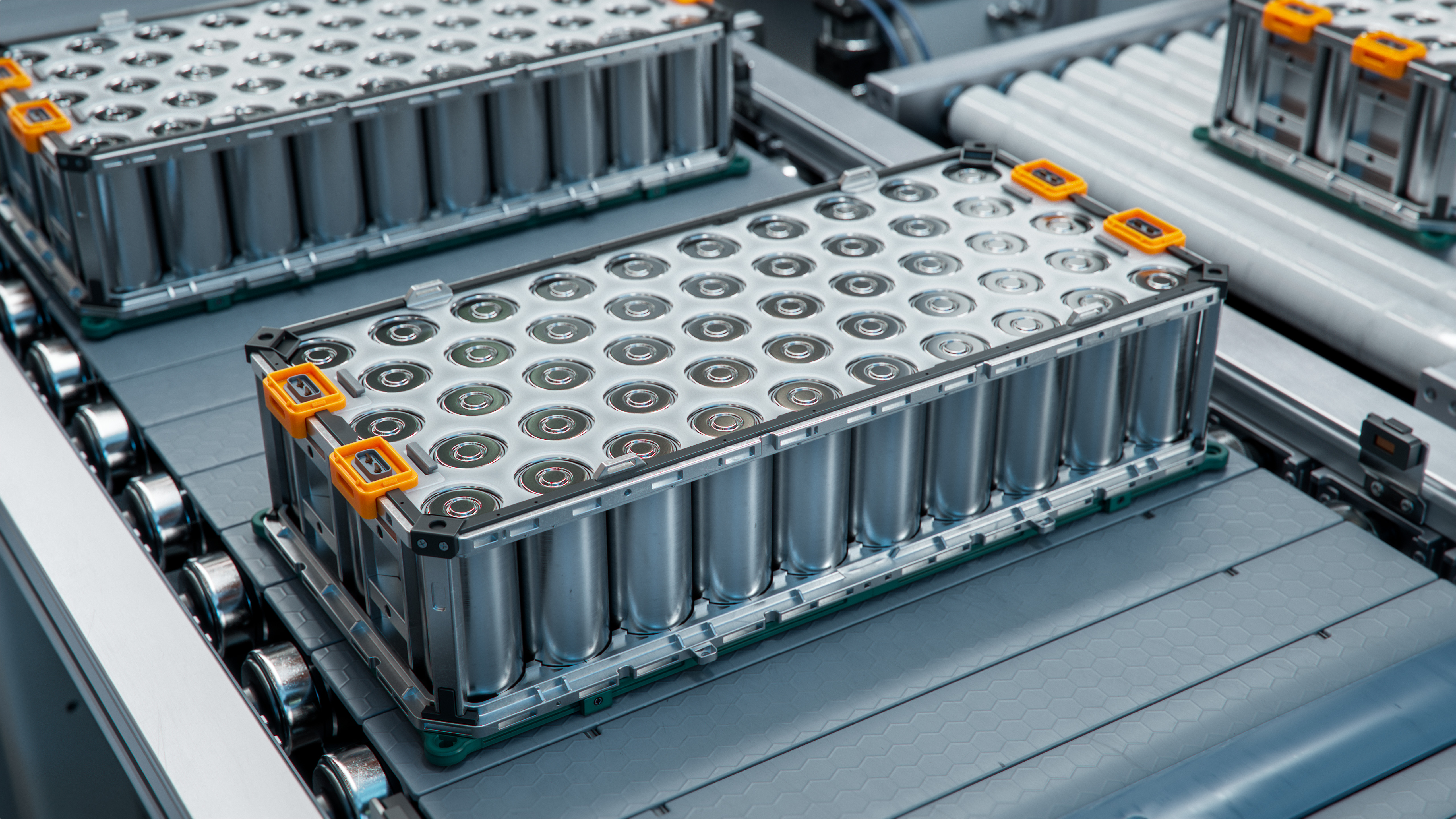 Industrial battery modules with orange accents mounted on gray vehicle platform