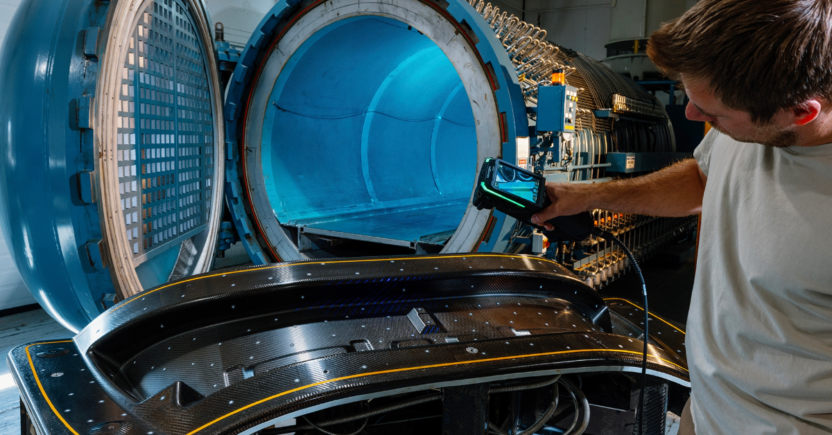 Technician operating a large blue hyperbaric chamber with internal monitoring equipment in a research facility