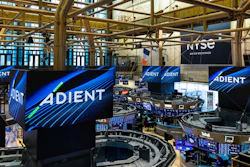 ADIENT branded displays and signage at a large indoor trade show or event venue with industrial architecture