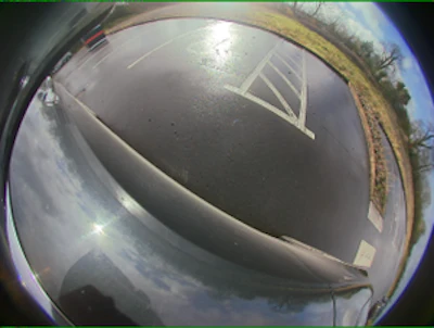 Fisheye view of curved industrial dome structure with metallic surface and sky reflection
