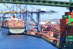 Container ship docked at busy port terminal with stacked cargo containers and loading cranes