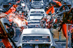 Robotic welding arms assembling white vehicles on an automotive manufacturing production line