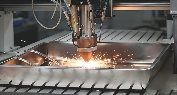 Industrial laser cutting machine creating bright sparks while cutting through metal sheet material